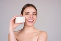 Closeup young woman applying cream to face. Skincare and cosmetics concept. Skin care. Girl applying cream on face on Royalty Free Stock Photo