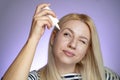 Closeup of young woman applying eye drops Royalty Free Stock Photo