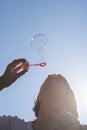 Closeup of young woman blowing soap bubbles Royalty Free Stock Photo