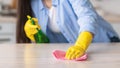 Closeup of young woman cleaning table with cloth Royalty Free Stock Photo