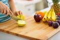 Closeup on young woman cutting apple Royalty Free Stock Photo