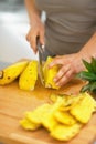 Closeup on young woman cutting pineapple Royalty Free Stock Photo