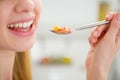 Closeup on young woman eating fruits salad Royalty Free Stock Photo