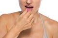 Closeup on young woman eating pill Royalty Free Stock Photo