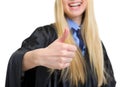 Woman in graduation gown showing thumbs up Royalty Free Stock Photo