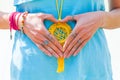 Closeup of young woman hands in heart shape with lot of boho style jewelry, rings and bracelets outdoor summer spring day Royalty Free Stock Photo