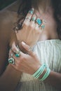 Closeup of young woman hands with lot of boho style jewrly, rin