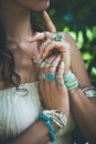 Closeup of young woman hands lot of boho style jewrly, rings and