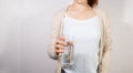 Closeup young woman holding drinking water glass in her hand Royalty Free Stock Photo