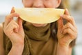 Closeup on young woman holding melon slice in front of mouth Royalty Free Stock Photo