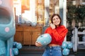 Closeup of a young woman holding an ornate pumpkin