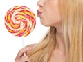 Closeup on young woman kissing lollipop Royalty Free Stock Photo