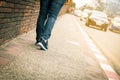 Closeup of young woman legs walk on sidewalk Royalty Free Stock Photo