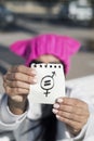 Woman with pussyhat and symbol for gender equality