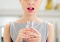 Closeup on young woman with pill in mouth Royalty Free Stock Photo