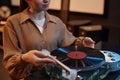 Closeup of young woman playing vinyl records at home in cozy setting Royalty Free Stock Photo