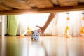 Closeup of young woman reaching under the bed and pressing snooze button on alarm clock Royalty Free Stock Photo