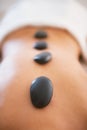 Closeup on young woman receiving hot stone massage Royalty Free Stock Photo