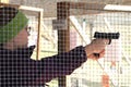 Closeup of young woman shooting pistol at shooting range Royalty Free Stock Photo