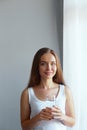 Closeup young woman show glass of water. Portrait of happy smiling female model holding transparent glass of water.Healthy lifesty Royalty Free Stock Photo