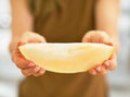 Closeup on young woman showing melon slice Royalty Free Stock Photo