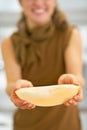 Closeup on young woman showing melon slice Royalty Free Stock Photo