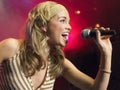 Closeup Of Young Woman Singing Into Microphone Royalty Free Stock Photo