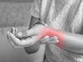 Closeup young woman sitting on sofa holds her wrist. hand injury