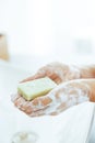 Closeup on young woman washing hands in modern white bathroom Royalty Free Stock Photo