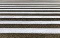 Closeup zebra pedestrian crossing on the asphalt road. White stripes on black road