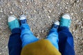 Closeupe of legs of an adult and a toddler in jeans and sneakers Royalty Free Stock Photo