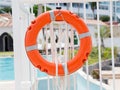 Closeyp orange lifebuoy on a white pool fence Royalty Free Stock Photo