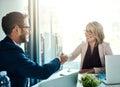 Closing another successful deal. two businesspeople shaking hands in an office. Royalty Free Stock Photo