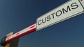 Closed barrier gate with CUSTOMS sign. Conceptual 3D rendering