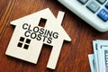 Closing costs. Model of house and money Royalty Free Stock Photo
