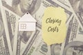 Closing costs are the various fees and expenses associated with the purchase or sale of real estate, typically incurred at the Royalty Free Stock Photo