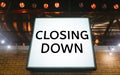 Closing Down sign painted on the window of a dress shop Royalty Free Stock Photo