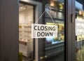 Closing Down sign painted on the window of a dress shop Royalty Free Stock Photo