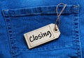 Closing tag on blue jean background.