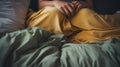closrup of person hand under blanket in bedroom bed