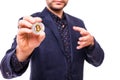 Closu up of handsome business man in suit with silver bitcoin in hand isolated on white background