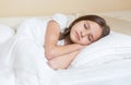 Closuep portrait of beautiful teenage girl with long brunette hair sleeping in bed