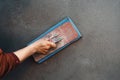 closup hand of workers plastering on wall outdoor construction site