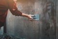 closup hand of workers plastering on wall outdoor in construction site