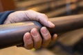 Closup male hand gripping metal tube in industrial factory