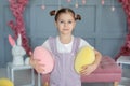 Closup portrait smiling Young girl with hairstyle buns. Beautiful little girl with big eyes playing with Easter eggs. Family holid Royalty Free Stock Photo