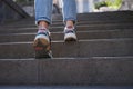 Closup of woman legs in sneakers walking up steps Royalty Free Stock Photo