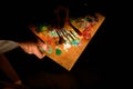 Closup of wooden palette in the hands of woman in the evening lighting