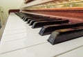 Closup of a wooden piano with two black keys in focus