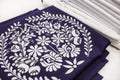 Closw up white embroidery on blue natural fabric. traditional ornament. Bed linen production